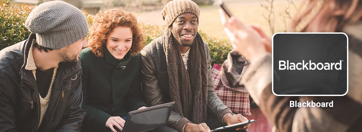 Students with laptops outside