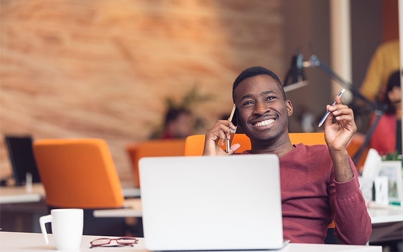 Man smiling with computer