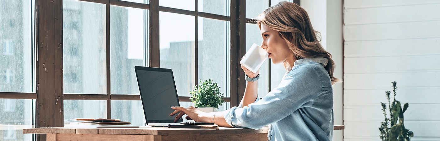 Woman working in home office at her computer with Xerox® Docushare® Go solution