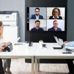 People in a meeting room in front of the Xerox® B410 printer