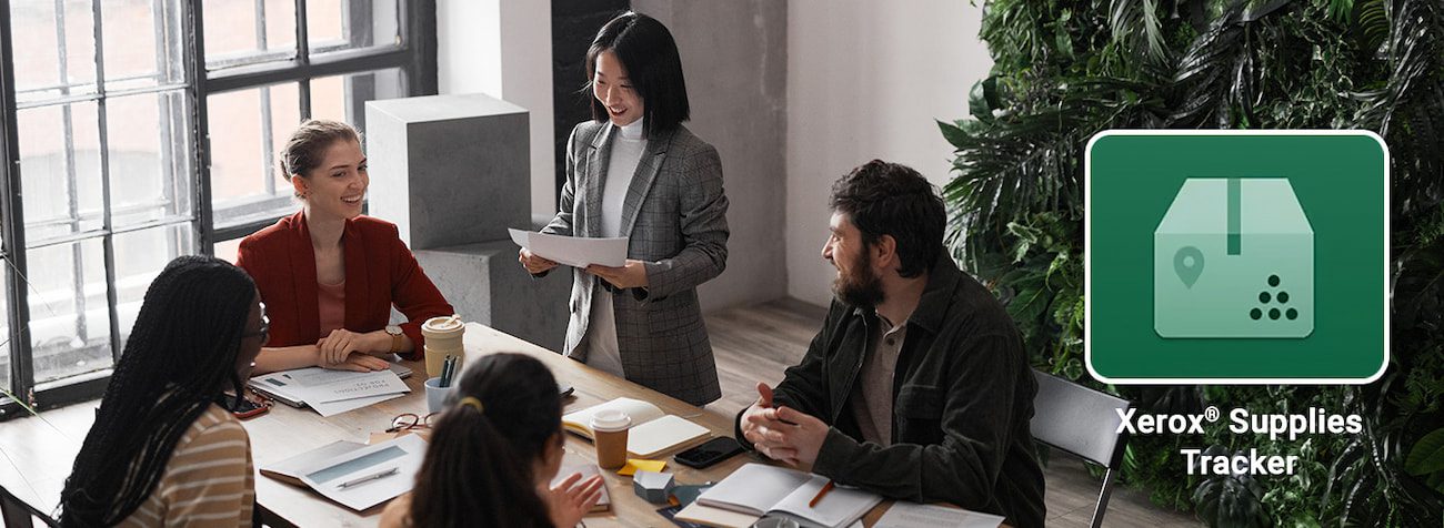 Picture of staff meeting with Xerox Supplies tracker logo