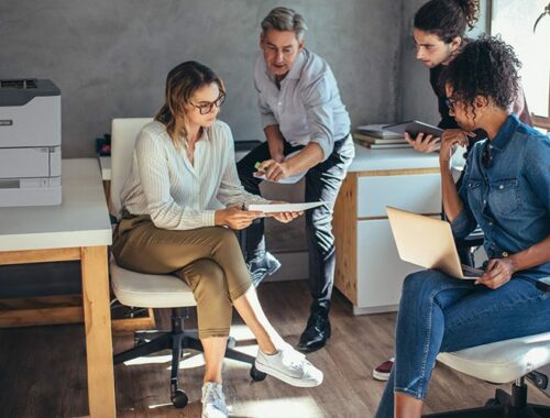 People in an office next to the Xerox® VersaLink® B620 printer